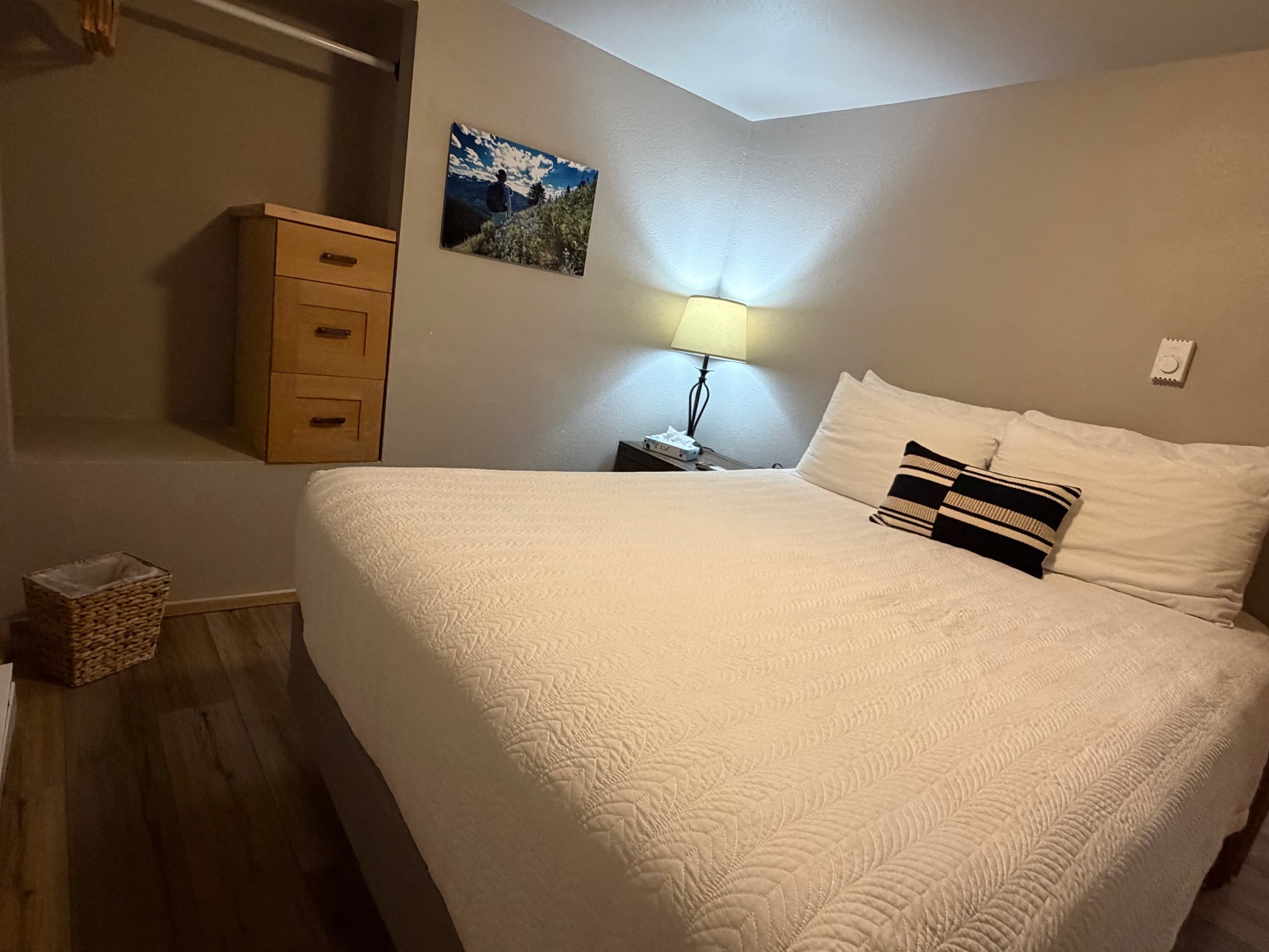 Bedroom Two with chest of drawers and open closet for hanging garments.